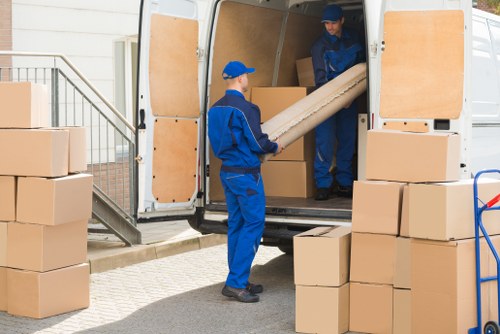 Moving boxes and furniture loaded into a removals van in St Johns Wood