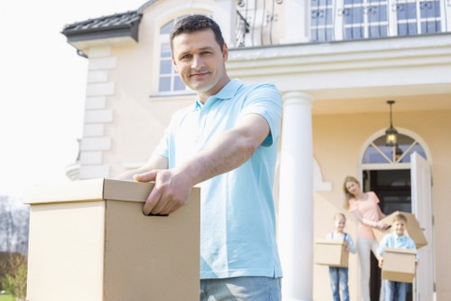 Removal team carrying furniture during a house move