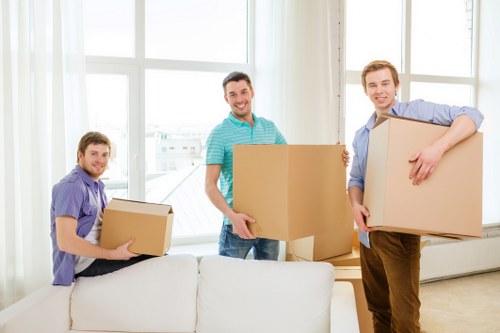 Moving team navigating a Stjohnswood residential block with furniture